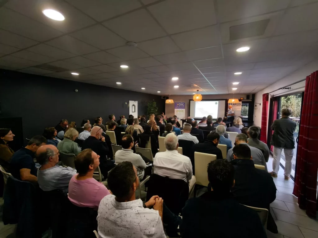 Conférence avec un public attentif en intérieur.